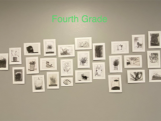 Fourth grade class artwork hung on wall